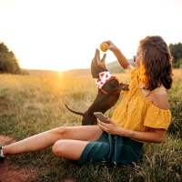 Woman playing with her dog  at Agave Courtyard in El Paso, Texas 