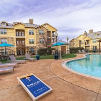 Inviting pool surrounded by sun loungers and vibrant landscaping at Blue Ridge in Midland, Texas