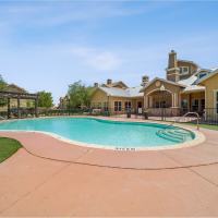 Inviting pool surrounded by sun loungers and vibrant landscaping at Blue Ridge in Midland, Texas