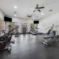 Modern gym with sleek equipment and bright lighting at Blue Ridge in Midland, Texas