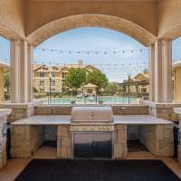 Outdoor kitchen with stainless steel grill and string lights at Blue Ridge in Midland, Texas
