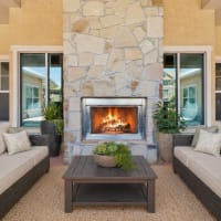 Inviting patio with couches and a roaring fire at Blue Ridge in Midland, Texas