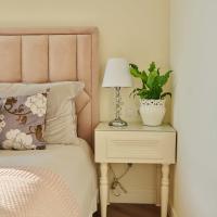 Cozy bedroom with soft pink headboard at Continuum 115 in Mooresville, North Carolina