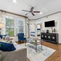 Luxurious well-lit living room at Aria Victoria Apartments in Victoria, Texas