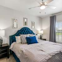 Luxurious well-lit bedroom at Residence at Lake Jackson in Lake Jackson, Texas