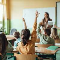 Bright classroom with students raising hands at a school near August Friendswood in Friendswood, Texas