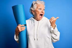 Happy woman holding yoga mat in Cedar Pointe in Arlington, Washington