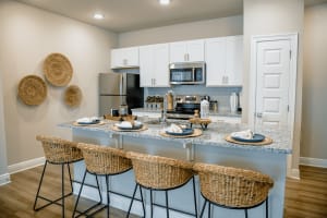 Model kitchen with wicker style seats at The Waters at Ransley in Pensacola, Florida