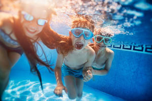 Happy kids swimming in pool at Casa Bella in Victorville, California