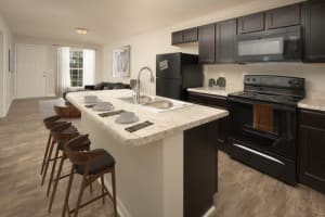 An apartment kitchen with an island at Ivy Terrace in Chattanooga, Tennessee