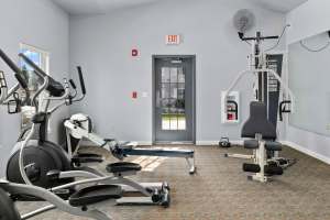 Resident picking up weights in the gym at Heron Creek Apartments in Moses Lake, Washington
