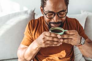 Resident sipping coffee at Troup Townhomes in Troup, Texas
