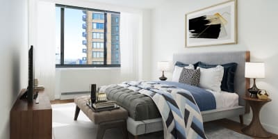 Modern decorated bedroom area with lots of natural light at Carnegie Mews in New York, New York