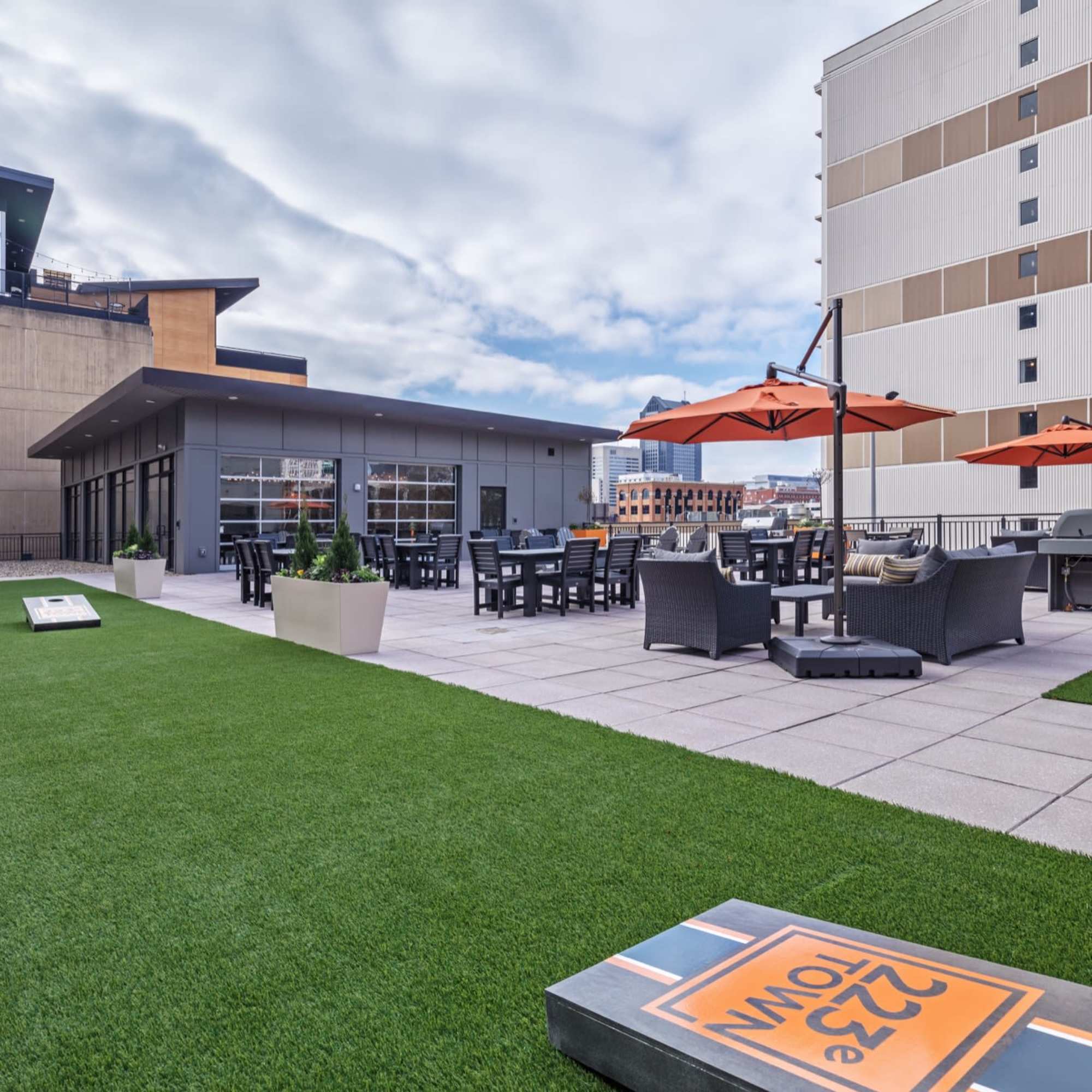 Outdoor seating area with orange umbrellas at 223 E Town in Columbus, Ohio