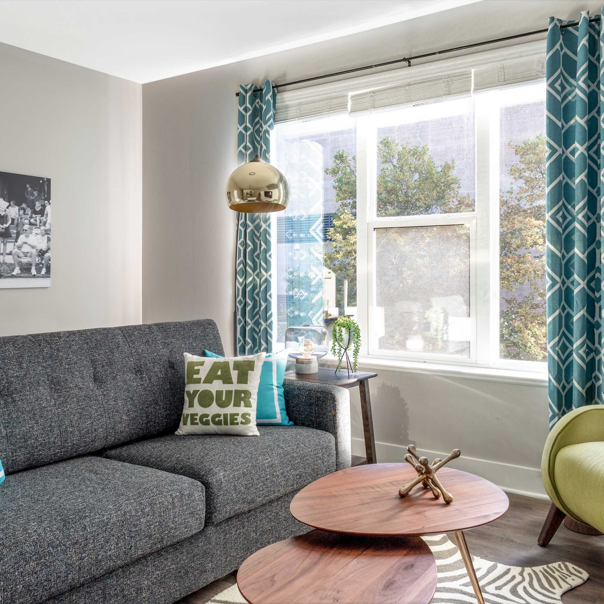 Gray couch with decorative pillows and tables at 223 E Town in Columbus, Ohio