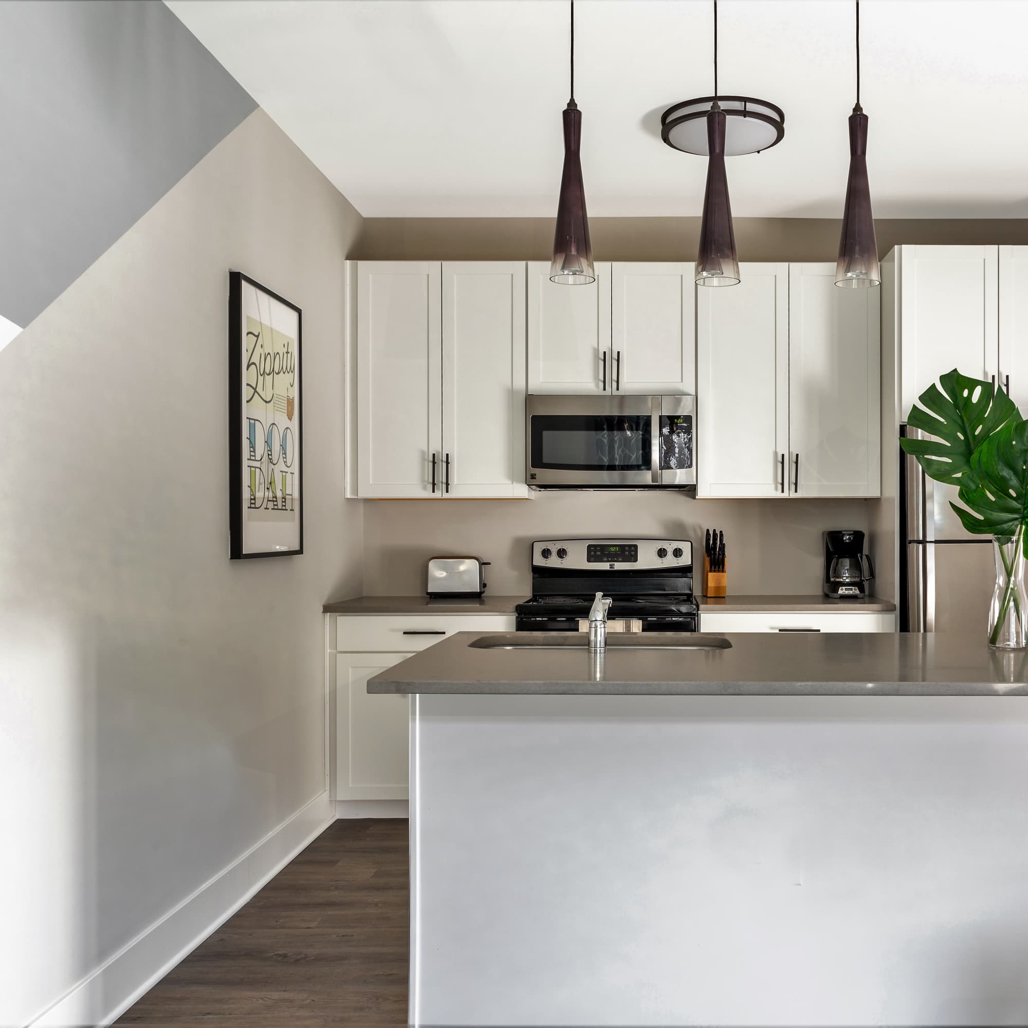 Kitchen island with sink and modern appliances at 223 E Town in Columbus, Ohio
