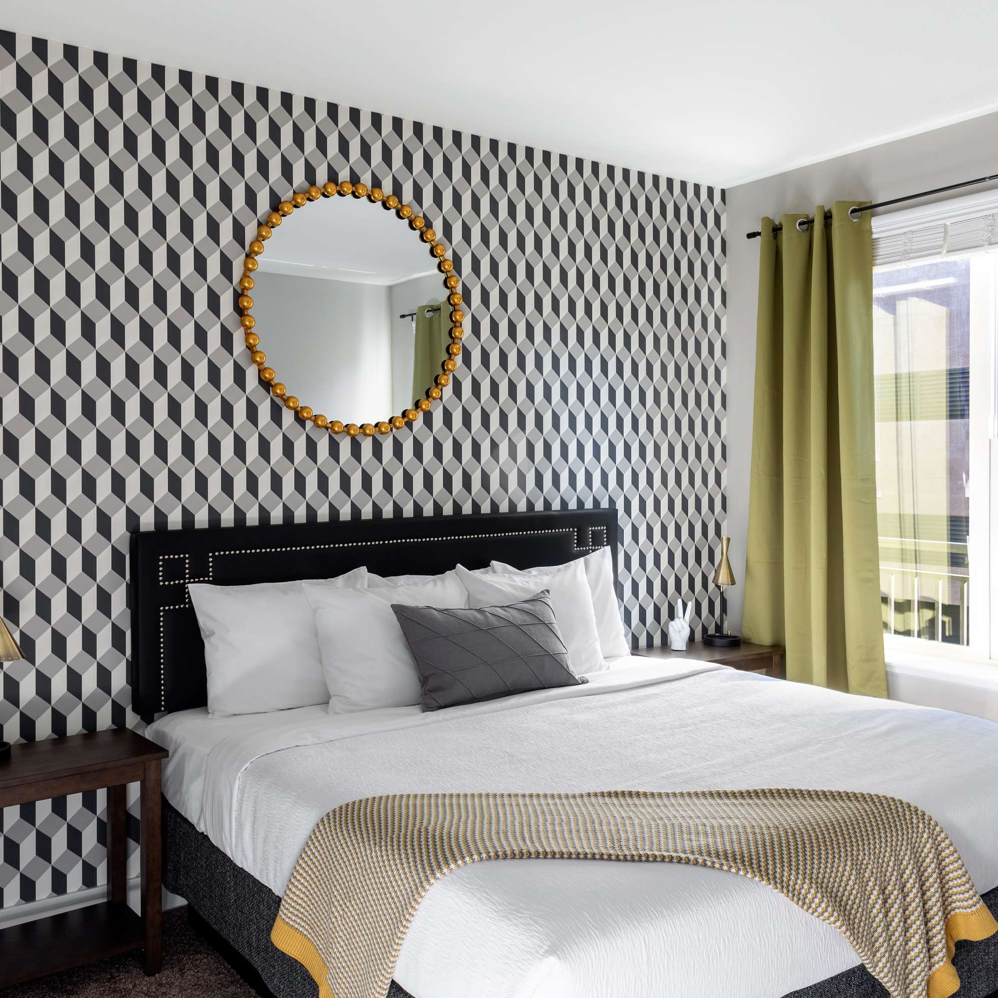 Geometric patterned wall with round mirror at 223 E Town in Columbus, Ohio