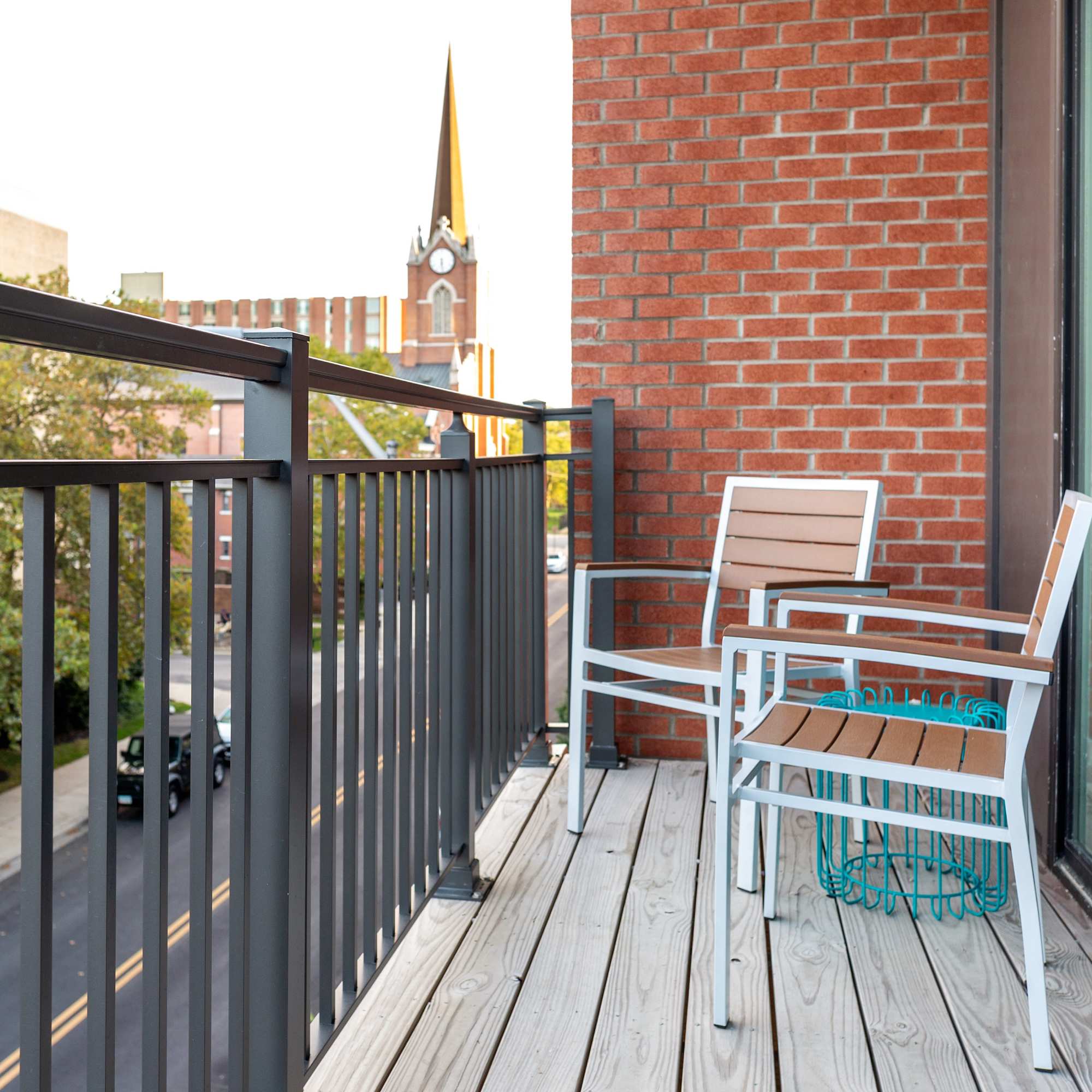 Two chairs on a balcony with a brick wall at 223 E Town in Columbus, Ohio