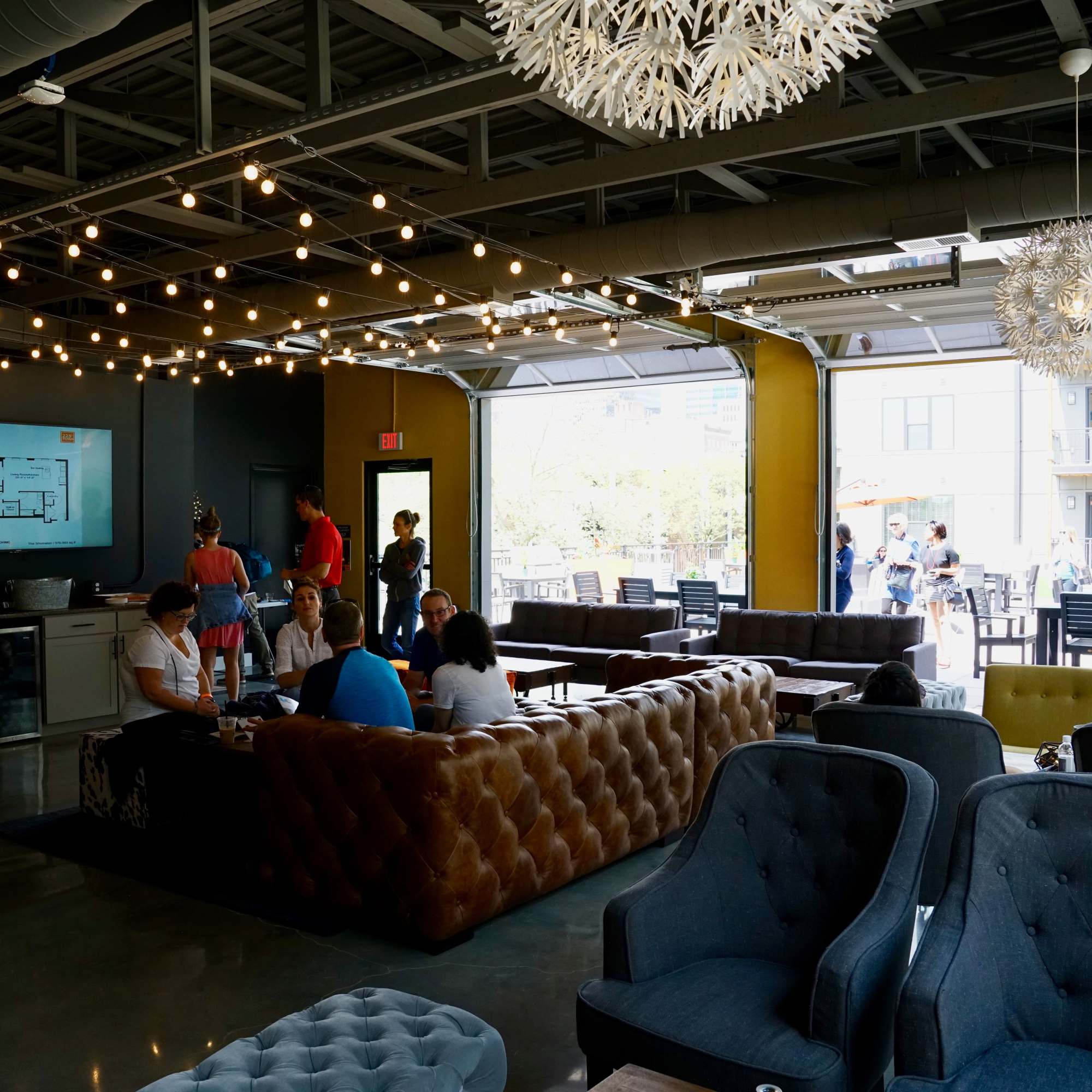 People seated on brown leather couches at 223 E Town in Columbus, Ohio