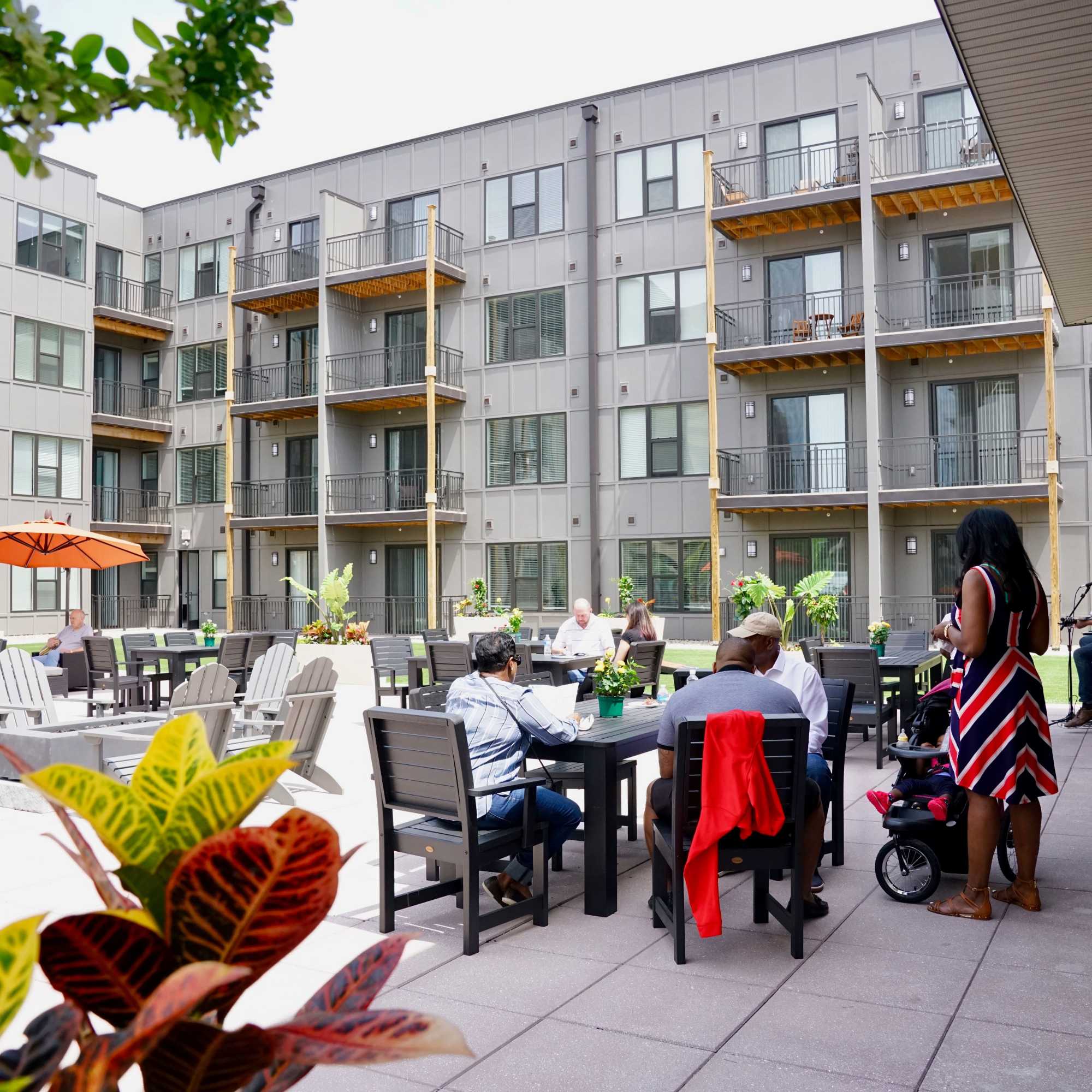 Gray building with balconies and outdoor seating at 223 E Town in Columbus, Ohio