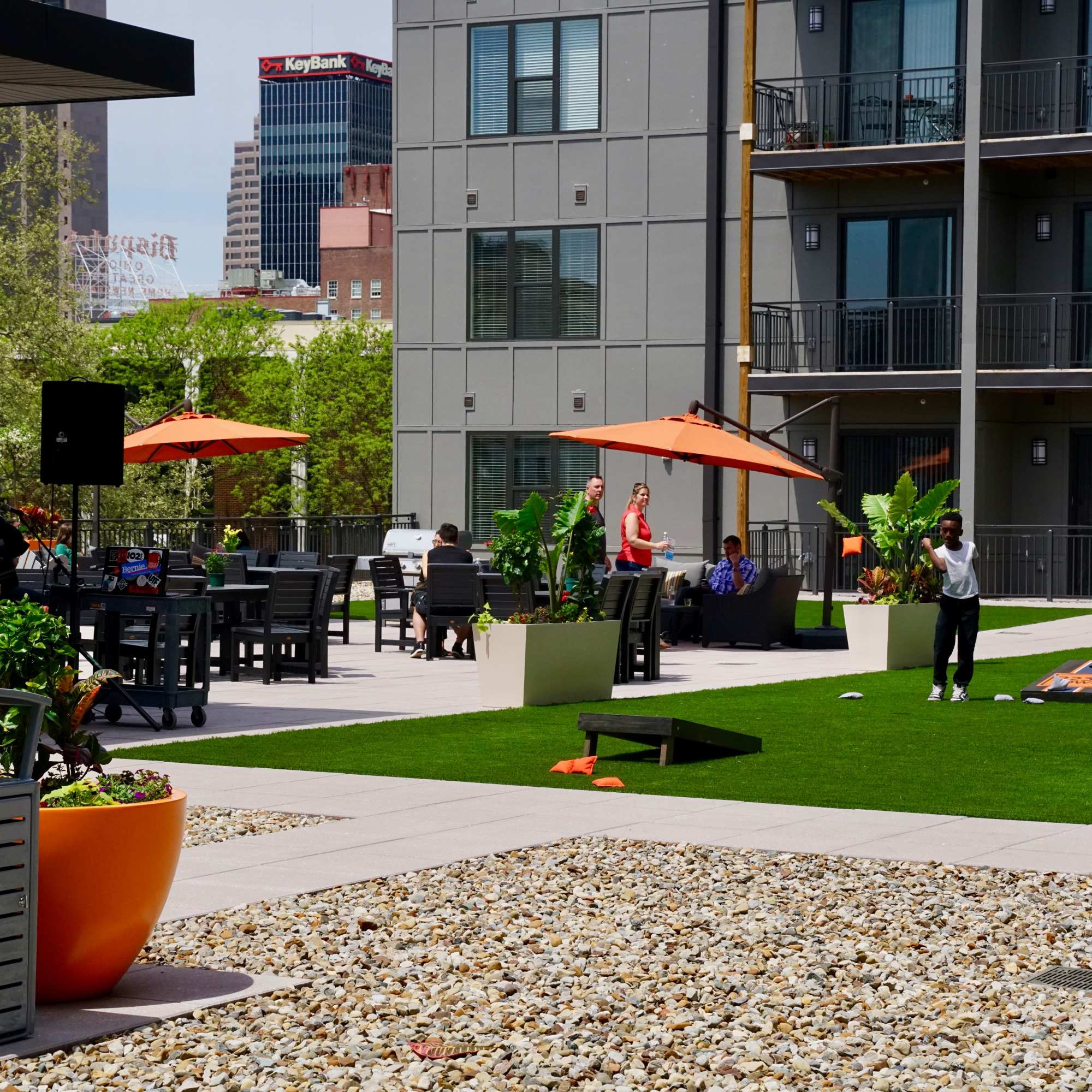 Person throwing a bean bag on grass at 223 E Town in Columbus, Ohio