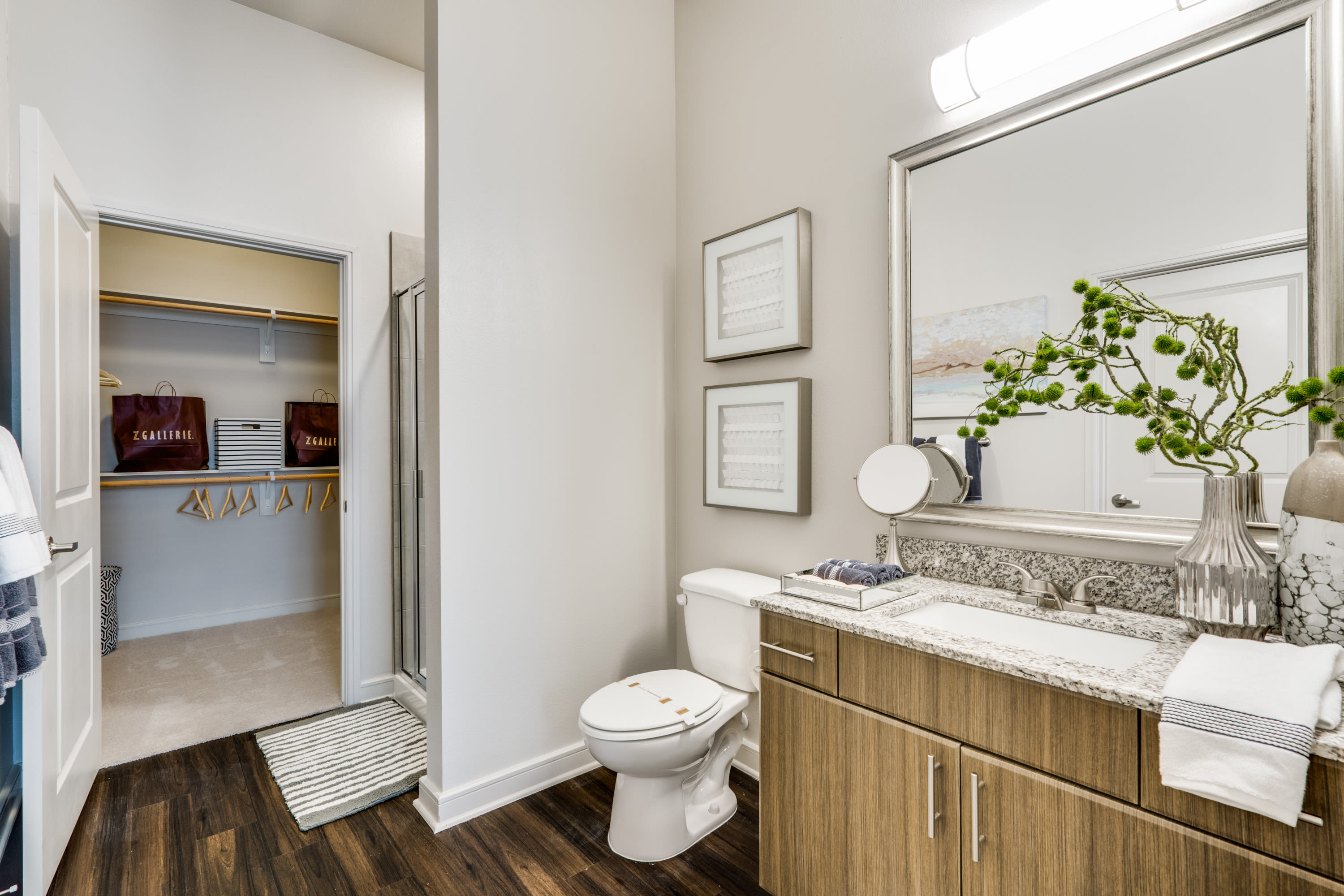 Wood-style flooring in the bathroom at 801 LasCo in Irving, Texas