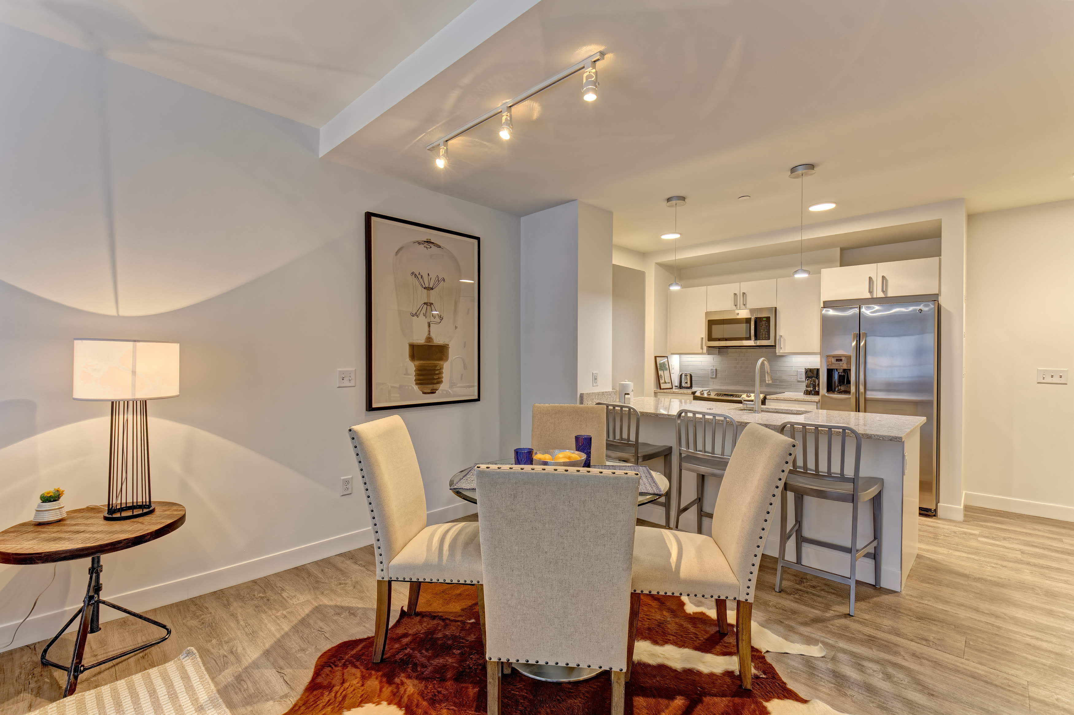 Spacious dining room with wood-style flooring at Vela on the Park in Stamford, CT