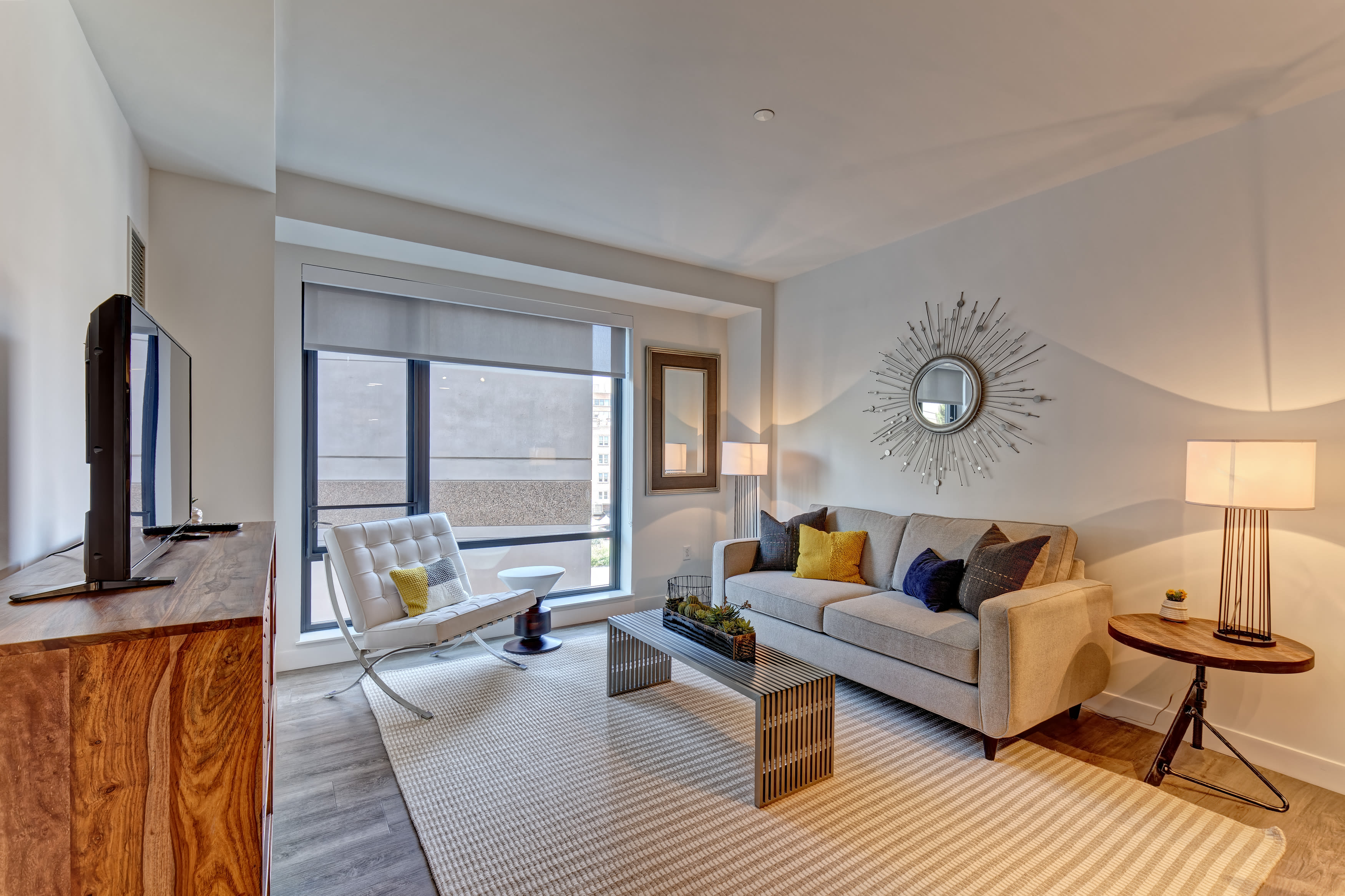 Beautiful living room with a large window at Vela on the Park in Stamford, Connecticut