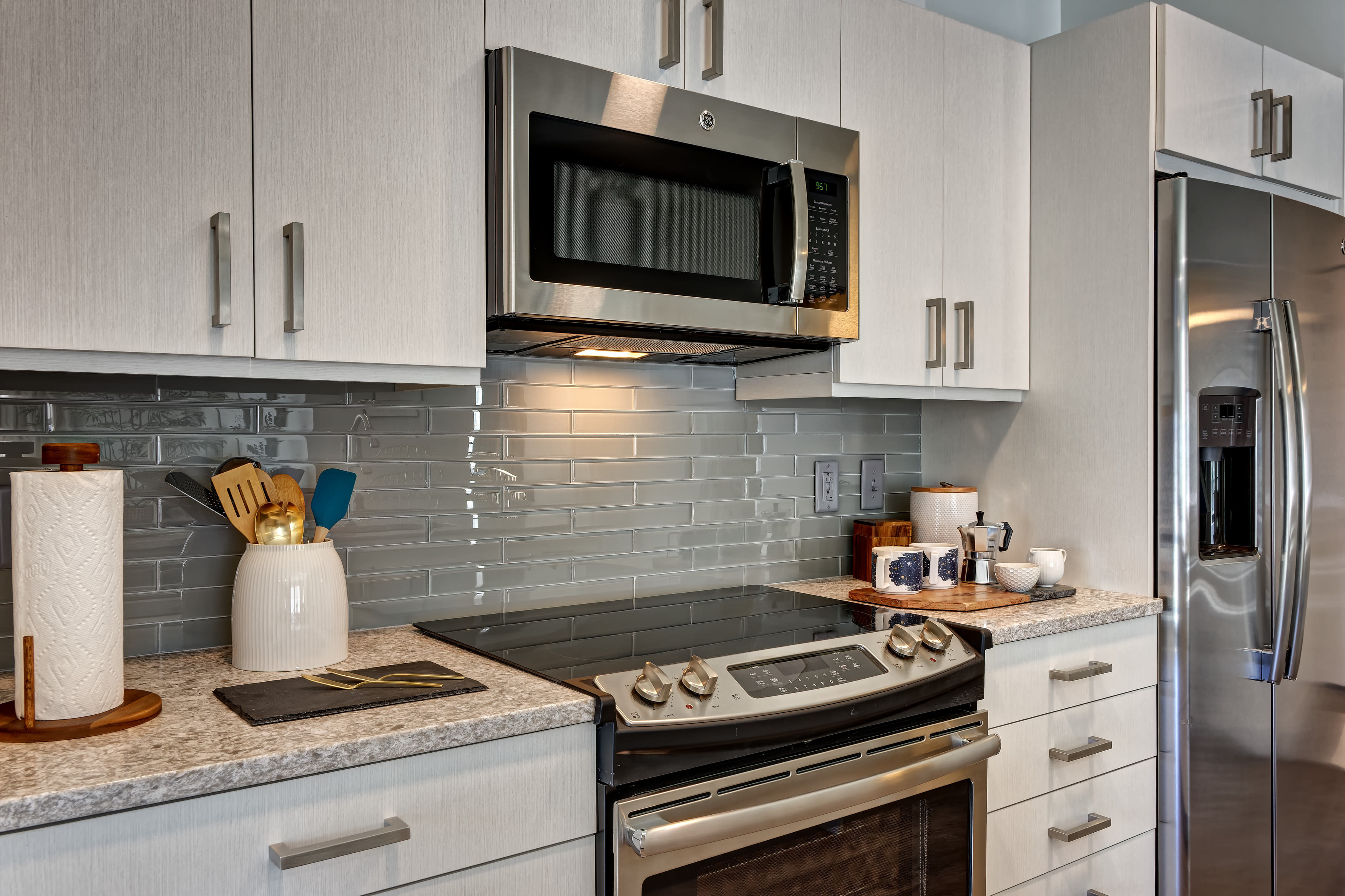 Kitchen with stainless-steel appliances and spacious counters at Vela on the Park in Stamford, CT