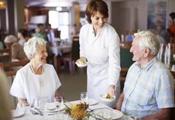 Older couple eating at The Welstone At Mission Crossing in Mission, KS