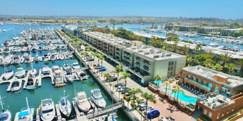 Sail boating on calm waters near Harborside Marina Bay Apartments in Marina del Rey, California