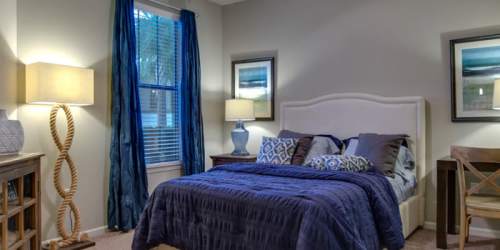 Bedroom with blue accents Whitepalm Luxury Apartment Homes in Port Orange, Florida