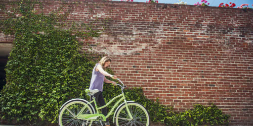 Resident walking her bike near Orchard City Lofts in Campbell, California