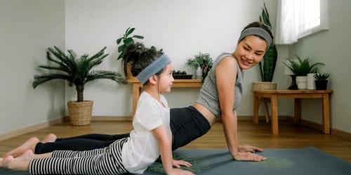 Mother and daughter doing yoga at Valencia Trace in Orlando, Florida