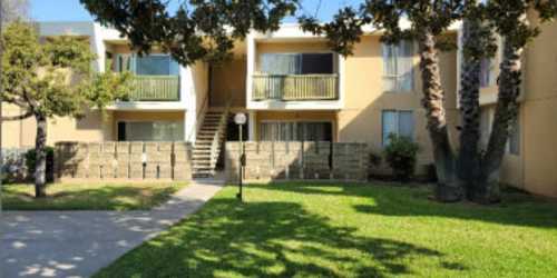 Apartment exterior view and green lawn at Lexington Green in El Cajon, California