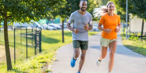 A couple jogging in the park on a sunny day at Countryside Apartments in Poway, California