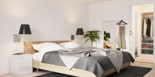 Bedroom with side lamps  at Oakfield Apartments in North Charleston, South Carolina