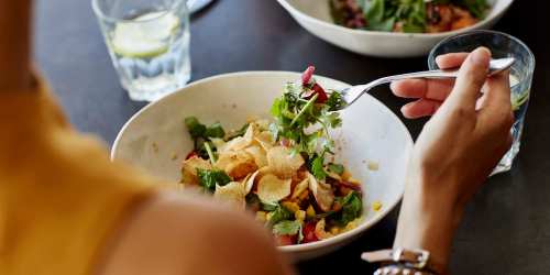 Resident eating salad in restaurant nearby Fairwind Apartments in North Charleston, South Carolina  