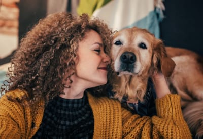 Happy resident and her dog in their new home at Hilltops in Conroe, Texas