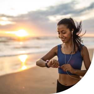 Woman running on the beach near Romero Apartments in Pensacola, Florida
