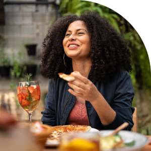 Woman enjoying a bite to eat near Romero Apartments in Pensacola, Florida