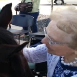 Resident Mary petting a horse at her Dare to Dream event at Milestone Senior Living Stoughton in Stoughton, Wisconsin