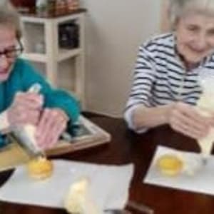 Resident Tura decorating cakes at her Dare to Dream event at Milestone Senior Living Stoughton in Stoughton, Wisconsin.