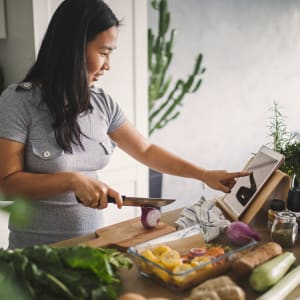 Resident preparing a fresh meal in the kitchen of  their new home at River Ranch in Sherman, Texas