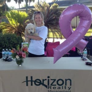 Employeeand her dog at a community event hosted by Horizon Realty.
