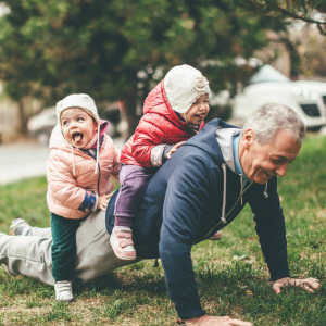 Resident playing with his grandkids outside at Lakeview Senior Living in Lakewood, Colorado.