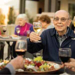 Residents raising a glass in a toast at Clearwater at North Tustin in Santa Ana, California