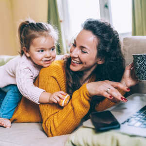 Resident mother with her daughter on the couch at Kent Place Residences in Englewood, Colorado