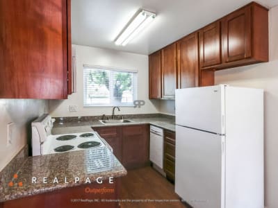 Model kitchen with wood flooring at Washington Townhomes in San Lorenzo, California