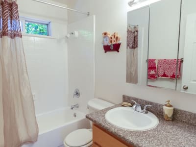 Model bathroom with granite countertop at Washington Townhomes in San Lorenzo, California